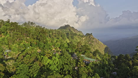 Ella-Sri-Lanka-Aerial-v7-establishing-drone-flyover-hillside-valley-towards-Little-Adam's-Peak-capturing-resort-hotels-and-beautiful-mountain-scenery-at-sunset---Shot-with-Mavic-3-Cine---April-2023