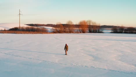 Person-ice-skate-on-frozen-pond,-enjoy-free-time-during-winter-sunset