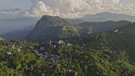 Ella-Sri-Lanka-Aerial-v3-drone-flyover-secluded-village-town-surrounded-by-mountainous-landscape-capturing-railway-station,-hillside-resort-hotels-and-residential---Shot-with-Mavic-3-Cine---April-2023