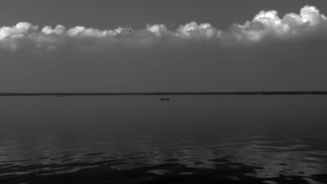 AERIAL-DRONE-VIEW-The-drone-is-moving-towards-the-camera-where-there-is-a-boat-going-in-the-middle-of-the-water