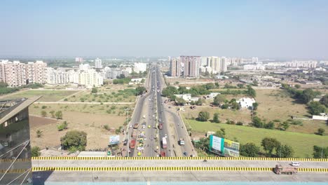 Aerial-drone-view-heading-towards-the-town-where-many-trucks-are-lining-up