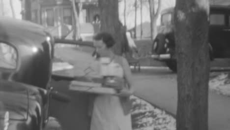 Woman-Gets-Out-of-a-Classic-Car-Carrying-Gift-Boxes-in-New-York-City-in-1930s