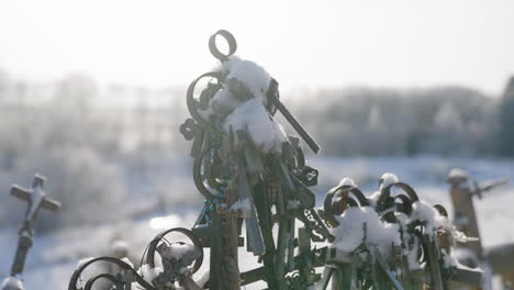 Ancient-religious-crosses-backlit-with-the-sun's-rays-in-a-close-up,-under-a-blue-sky,-cinematic-shot-in-slow-motion