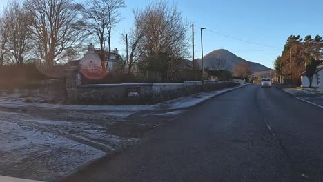 POV-shot-driving-through-cottages-in-Glencoe-with-road-works-being-carried-out