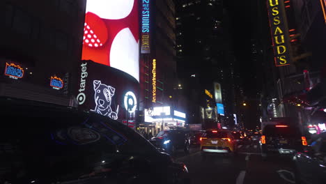 POV-shot-passing-stores-and-the-The-Duke-on-42nd-Street-theater,-night-in-New-York