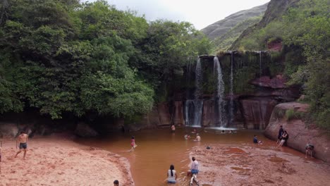 People-enjoy-nature-at-Las-Cuevas-Waterfall-in-Bolivian-mountains