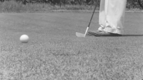 Golfer-Performes-a-Putt-on-a-Sunny-Day-at-the-Golf-Course-in-New-York-in-1930s