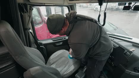 Man-expertly-uses-an-upholstery-seat-polisher-to-bring-a-lustrous-shine-to-the-interior-seats-of-a-truck-trailer