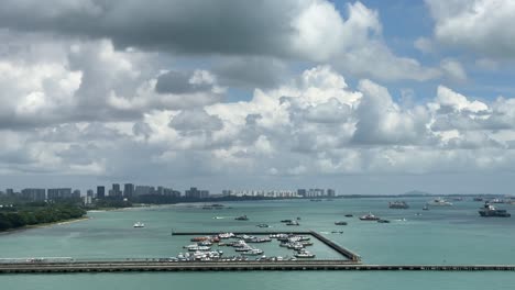 View-of-boats-docked-at-the-pier-and-moving-boats-navigating-in-the-Straits-of-Singapore