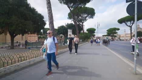 People-On-Electric-Scooters-Passing-Crowds-Near-Ancient-Ruins-|-Rome-Immersive-POV:-Moving-In-Busy-Streets-to-Chiesa-Santi-Luca-e-Martina,-Italy,-Europe,-Walking,-Shaky,-4K