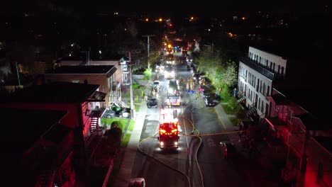 Slow-Aerial-Shot-Swooping-Down-on-Firefighters-Responding-to-Emergency