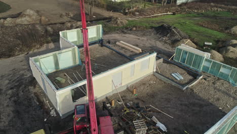 Vista-Aérea-Del-Sitio-De-Una-Casa-Prefabricada,-Donde-Ventanas-Y-Paneles-Esperan