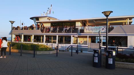 Passengers-waiting-for-the-departure-on-the-catamaran-boat-to-cruise-around-Lake-Balaton-in-Balatonfüred,-Hungary