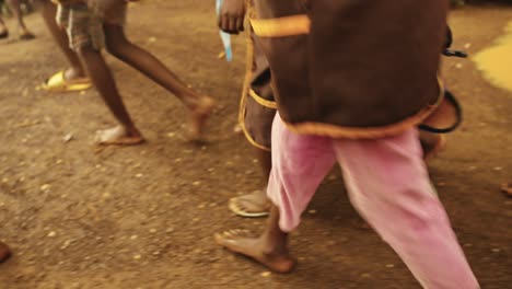 Poor-children-with-no-shoes-walking-to-school-on-the-dusty-road-in-Madagascar,-Africa