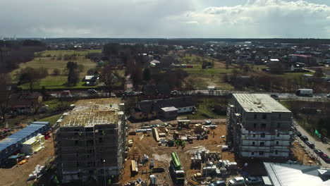 Aerial-view-of-the-location-of-two-apartment-buildings-where-carpenters-are-installing-the-roofs