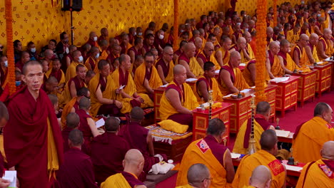 Ethnic-unity-in-prayer-of-Buddhist-religion-at-Monastery-of-Nepal,-tradition-by-Lama-guru-and-Lama-students,-holy-ceremony-drone-shot-4K