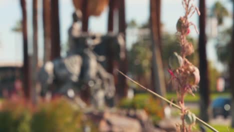 Berühmte-Große-Statue-Im-Stadtzentrum-Von-Palm-Springs,-Regalfokus-Mit-Gartenblume-Unter-Dem-Palmenboulevard