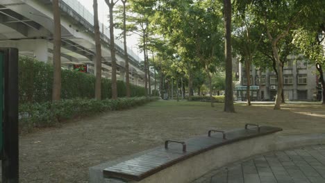 Green-Huashan-Park-sign-with-Chinese-characters-in-Taipei,-Taiwan,-amidst-a-tranquil-park-setting-with-trees