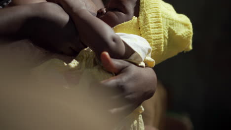 Impoverished-African-mother-removes-her-breast-for-nursing-of-her-hungry,-crying-girl-baby-and-breastfeeds-the-infant