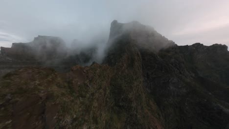 FPV-drone-flying-in-the-mountains-through-fog-over-the-clouds-at-Madeira-island