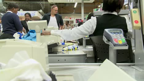 South-African-supermarket-till-attendant-at-busy-checkout-lane-with-customers