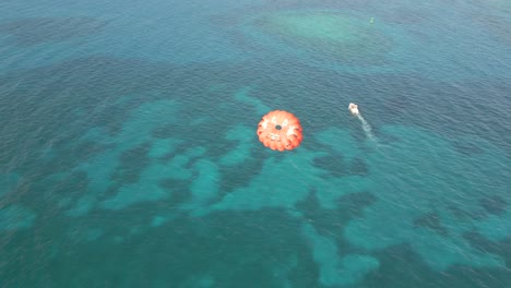 Luftaufnahme-Von-Touristen-Beim-Parasailing-über-Dem-Blauen-Wasser-Der-Karibik