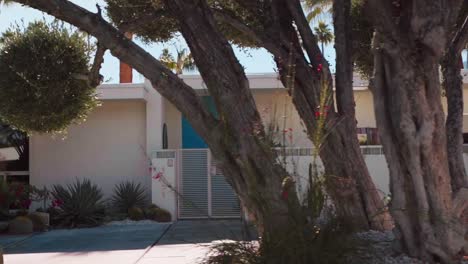 driving-residential-area-of-Palm-Springs,-trendy-modern-house-with-natural-mountain-landscape