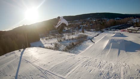 Snowboarder-makes-a-challenging-jump,-grabs-the-toe-side-of-the-board-and-lands-perfectly-in-slow-motion