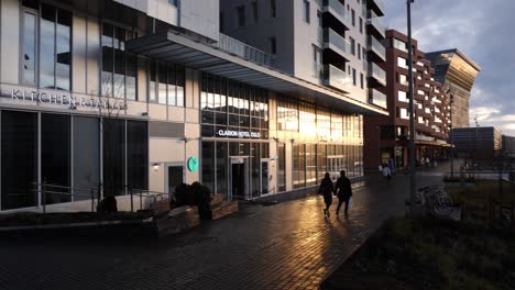 Golden-light-from-the-setting-sun-reflects-off-the-wet-streets-in-the-barcode-area-of-oslo,-Norway