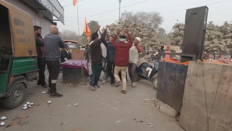 Festive-Indian-Hindu-men-dancing,-celebrating-consecration-of-ram-mandir-in-Ayodhya-chanting-jai-Shree-ram-together-in-joy