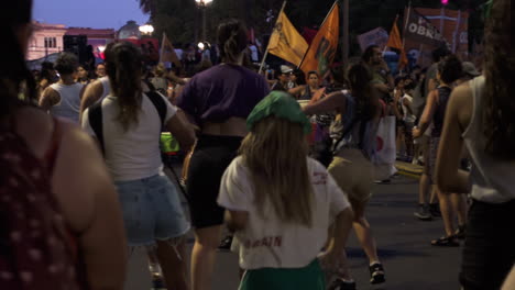 Un-Grupo-De-Mujeres-Y-Niñas-Realizan-Alegremente-Coreografías-Vestidas-De-Verde-Y-Morado-En-Representación-De-Los-Valores-Feministas-Durante-Una-Manifestación-Sobre-El-Aborto-Por-La-Noche.