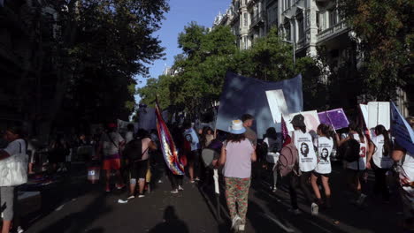 slow-motion-of-Argentinian-street-protest,-people-march-with-flags,-posters,-signs-and-che-guevara-prints-to-represent-indigenous-people