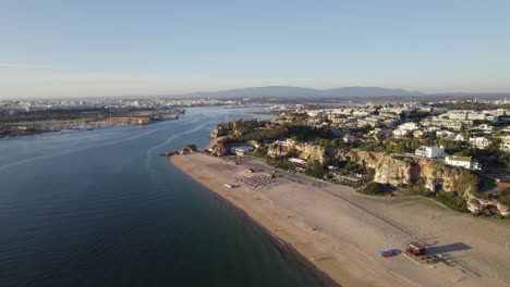 Aerial-wide-view-of-Praia-Grande-beach-by-Arade-River-in-Ferragudo,-Algarve