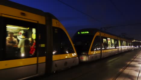 Night-train-with-passengers-passing-by-in-Gaia,-Portugal