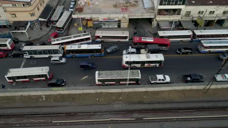 Buenos-Aires-city-traffic-congestion-with-cars-and-buses-lined-up-on-a-busy-street,-late-afternoon