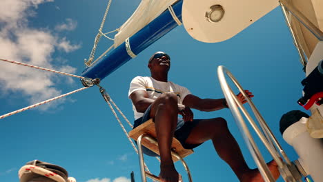 African-captain-driving-a-catamaran