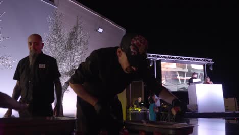 Establishing-shot-of-a-chef-plating-up-entrees-for-waiters-to-feed-to-guests