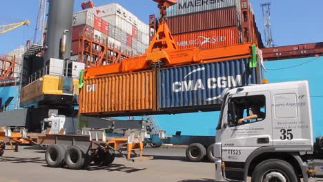 Cargo-container-being-lifted-at-a-busy-port,-clear-skies-at-port-of-Buenos-Aires