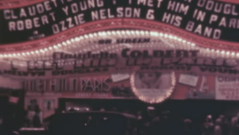 People-Walk-Under-an-Lighted-Marquee-in-New-York-in-1930s