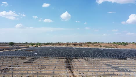 Aerial-drone-view-Drone-camera-moving-from-a-side-angle-where-the-rays-of-the-setting-sun-are-shining-and-power-stations-are-visible-in-between