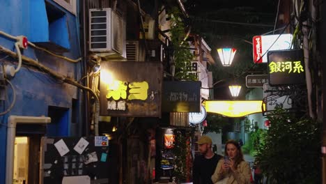 Slow-motion-pan-across-many-little-bars-and-izakaya-in-shinjuku-suburb