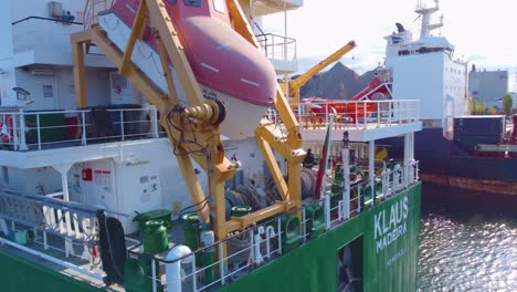 Aerial-Around-Stern-Of-Klaus-Cargo-Ship-With-Lifeboat