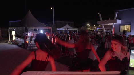 Close-up-shot-of-a-trio-of-dancers-performing-at-a-corporate-event-at-night