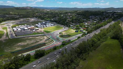 Rotating-aerial-view-of-the-SkyRidge-residential-development-on-a-sunny-day-adjacent-to-the-M1,-Worongary,-Gold-Coast