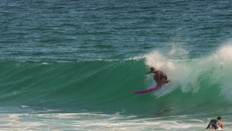 Surfers-enjoying-the-waves-on-a-sunny-day,-Burleigh-Heads,-Gold-Coast,-Australia