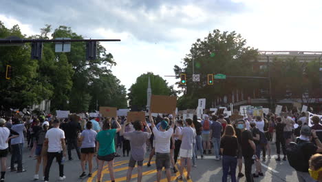 Black-lives-matter-protestors-holding-up-cardboard-signs-in-the-city-streets