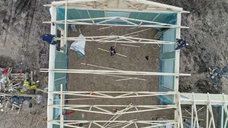 Men-are-Assembling-the-Framework-for-a-Roof---Aerial-Shot