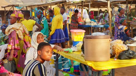 woman-in-traditional-clothing-working-in-local-market-selling-goods-food-and-items