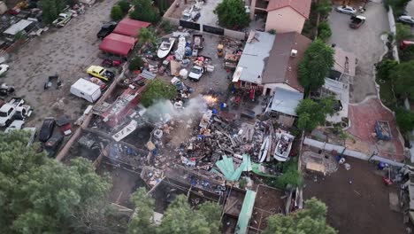 people-burning-trash-in-their-backyard-in-a-residential-community-in-san-bernardino-southern-california-dirty-landscape-AERIAL-ORBIT