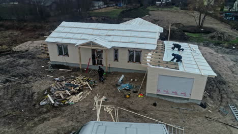 Workers-working-on-a-roof-contruction-of-a-large-villa